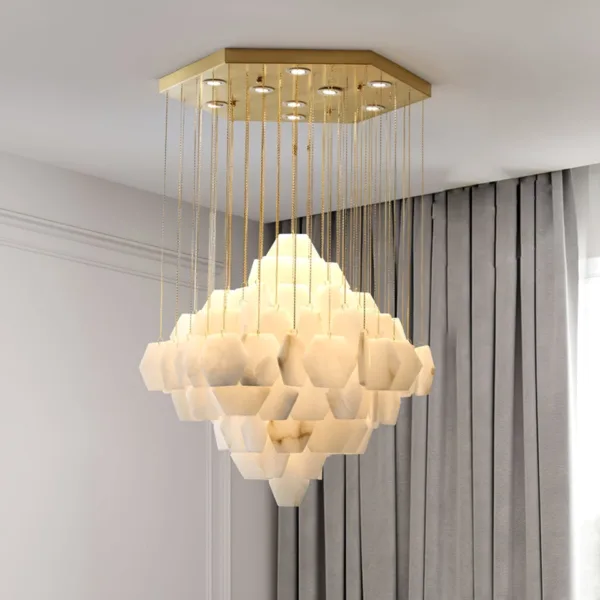 Round alabaster hexagon chandelier lit in a room with curtains