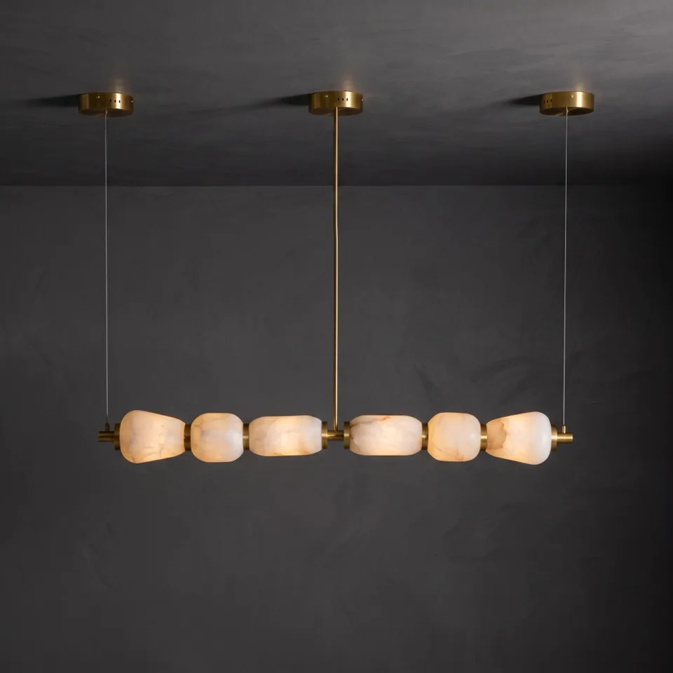 Alabaster Kitchen Island Chandelier 2 Alabaster linear chandelier hanging from three round brass ceiling plates, lit