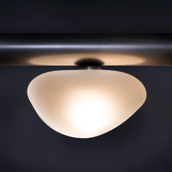 Organic frosted dome detail of the alabaster pebble linear chandelier, lit