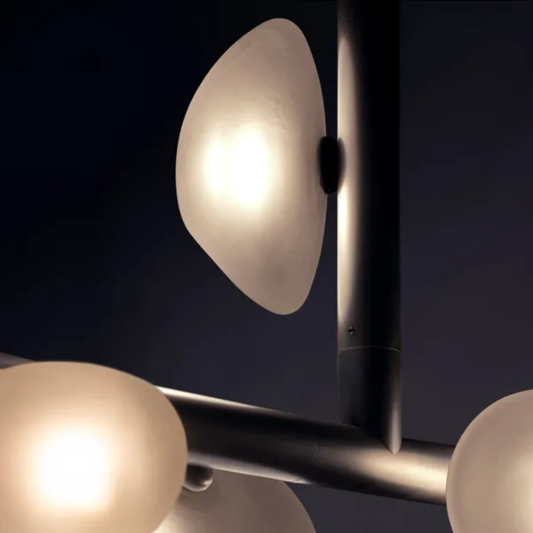 Close-up of a frosted pebble dome on the alabaster pebble linear chandelier, lit