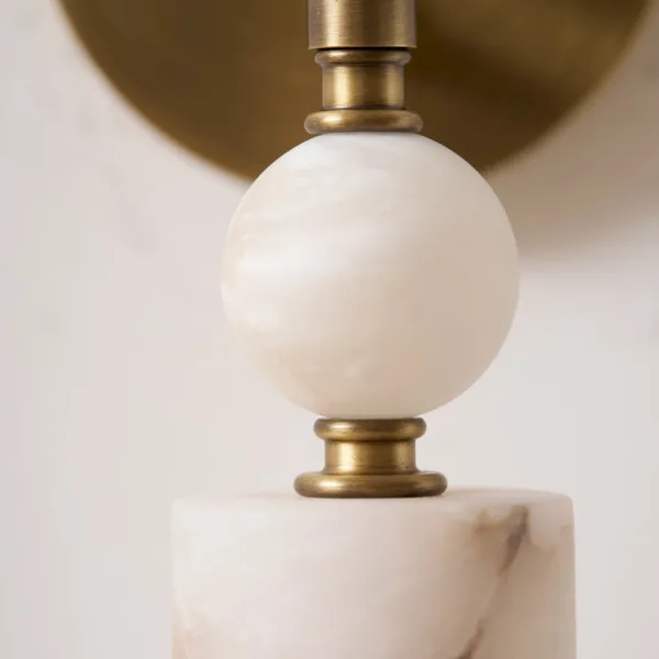 Close-up of the polished alabaster ball between brass-finish rings