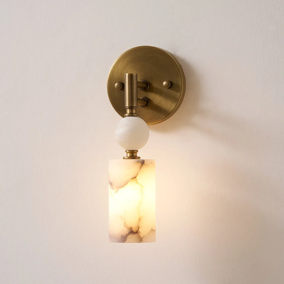 Home 2 Alabaster pendant wall light glowing warm, ball and cylinder on a brass-finish arm