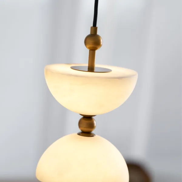 Close-up of a lit alabaster bowl on the alabaster staircase chandelier