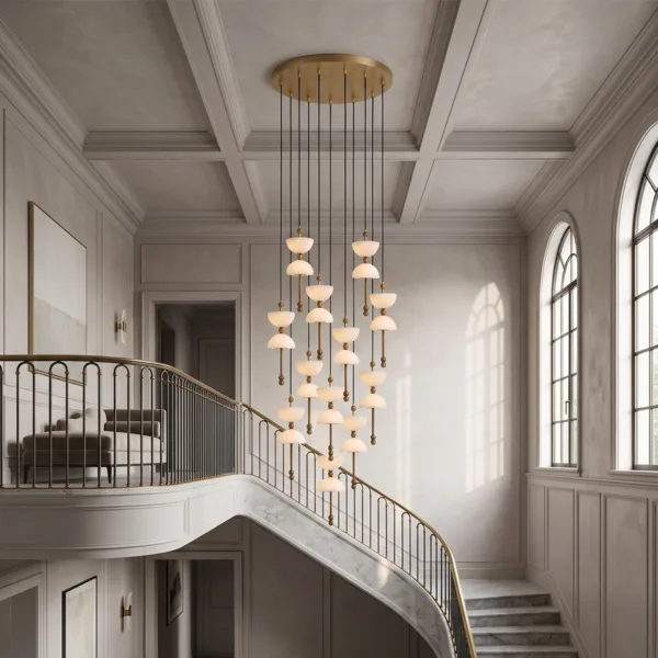 Alabaster staircase chandelier lit in a hall with a curved staircase and arched windows