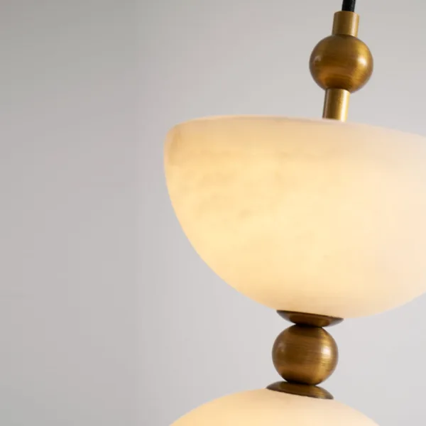Close-up of an alabaster bowl and brass ball on the alabaster staircase chandelier
