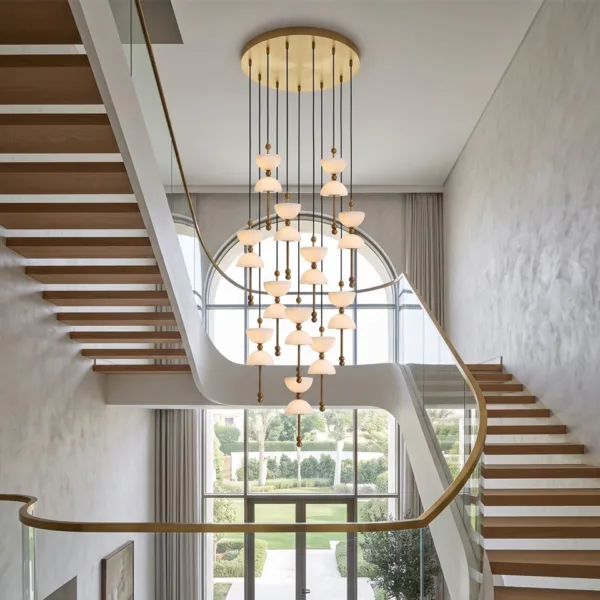 Alabaster staircase chandelier in a double-height hall with a glass-railing staircase