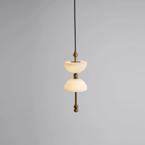 Single lit alabaster pendant from the alabaster staircase chandelier on a black cord