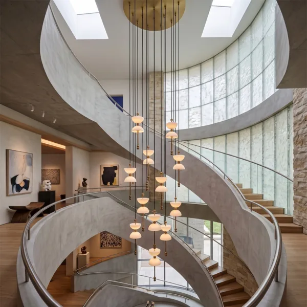 Alabaster staircase chandelier in the well of a spiral staircase