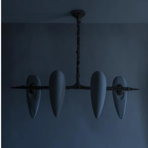 Four-alabaster teardrop chandelier unlit against a dark blue-grey wall