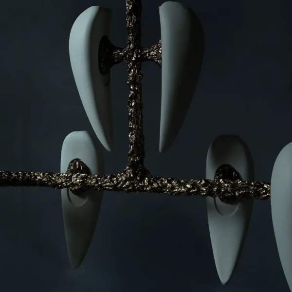 Close-up of the long cast metal arm and white alabaster teardrops on a dark background