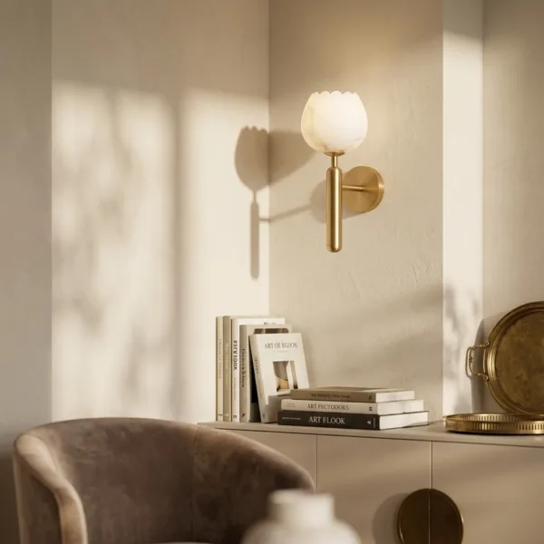 Alabaster tulip sconce above a sideboard and armchair in a sunlit room