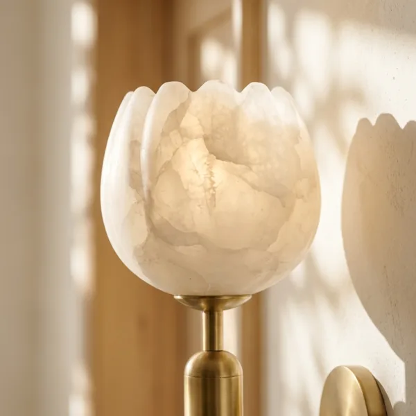 Close-up of the lit alabaster tulip shade showing natural stone veining