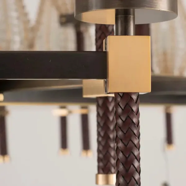 Braided brown cord on a post with a brushed brass block, close-up
