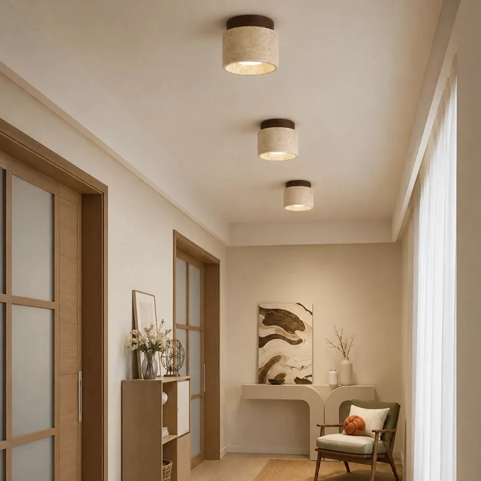 Cylindrical Ceiling Light – Travertine Drum, Wood Canopy, G9, 12 cm 1 A row of cylindrical ceiling light fittings in travertine lighting a corridor with glazed doors