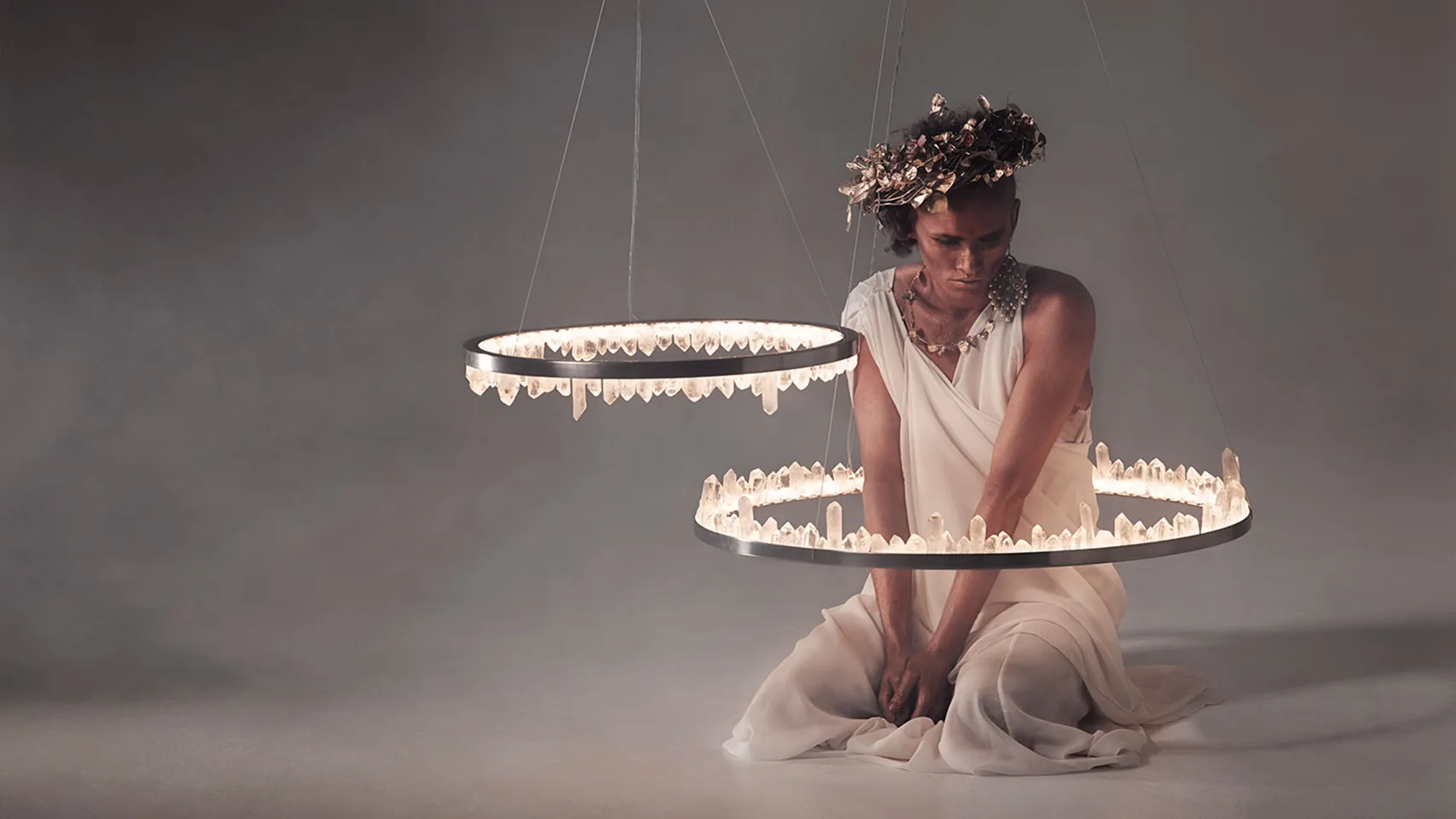 Home 9 Crystal ring chandeliers glowing around a woman in white, decorative lights by Jagmag Lights