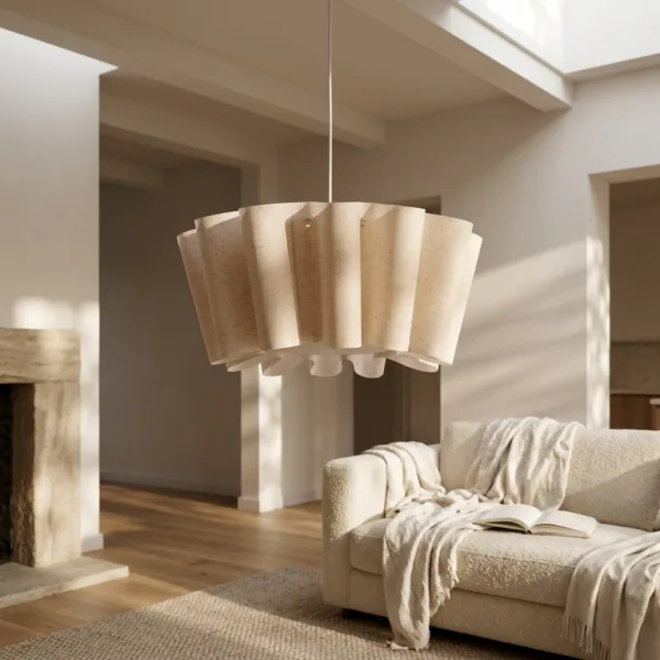 Draped fabric pendant light hanging over a cream boucle sofa in a bright living room with a stone fireplace