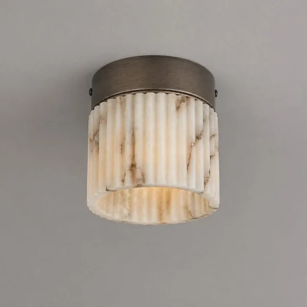 Close-up of the hand-carved alabaster flutes and the stainless steel canopy of the fluted light
