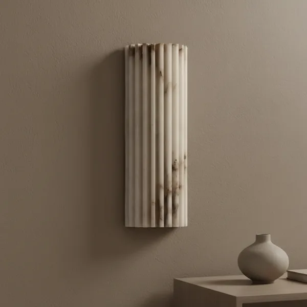 Fluted alabaster wall light switched off on a taupe wall, milky white stone with grey veins