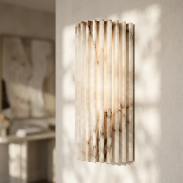 Three-quarter view of the fluted alabaster wall light showing natural stone veining in each rib