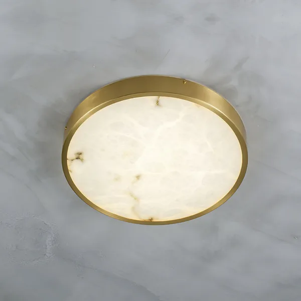 Round gold alabaster ceiling light seen at an angle