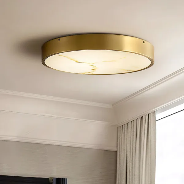 Round gold alabaster ceiling light in a living room with curtains