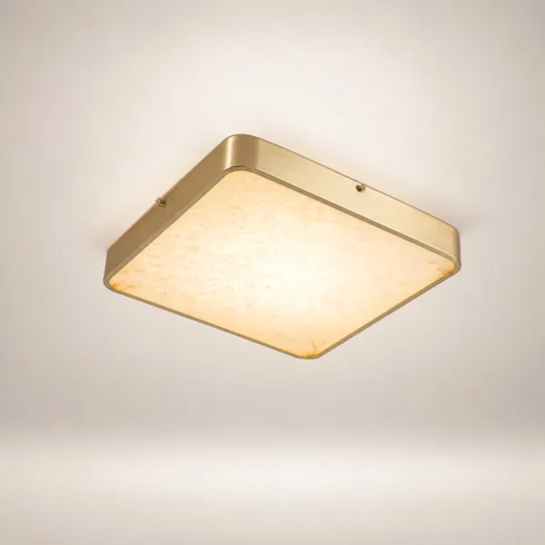 Square gold alabaster ceiling light glowing on a white ceiling