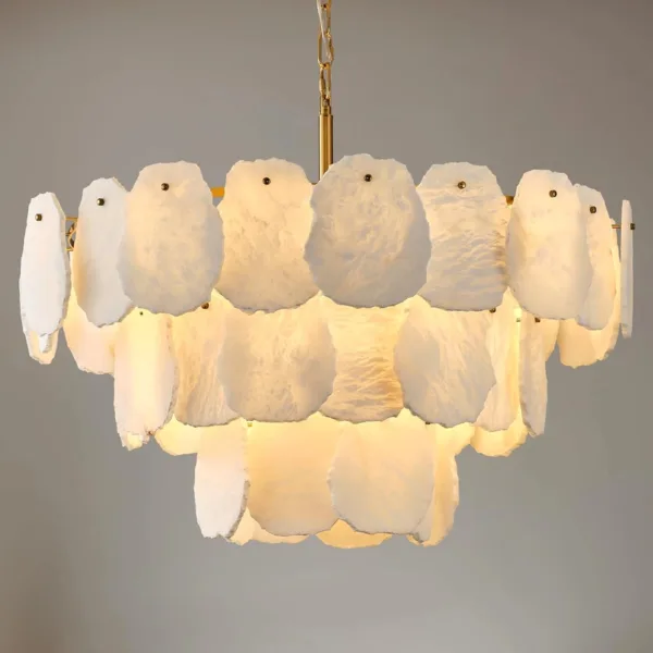 Layered alabaster chandelier lit, raw-edged slabs glowing warm