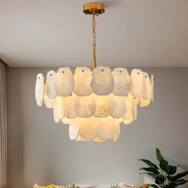 Round alabaster chandelier lit in a living room