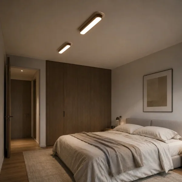 A pair of travertine and wood linear lights on a bedroom ceiling above a made bed