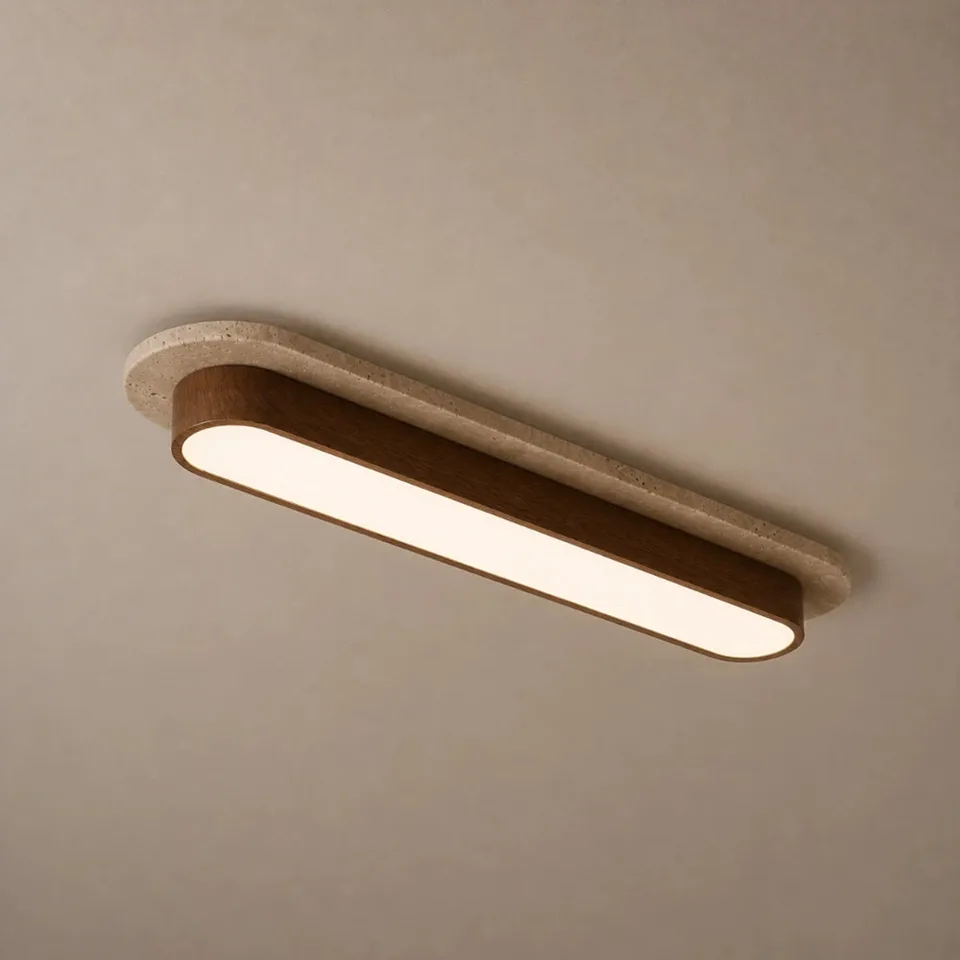 Home 4 Linear ceiling light in natural travertine and walnut-tone wood, its long white diffuser lit warm