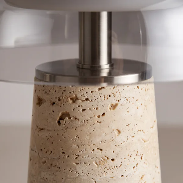 Detail of the steel stem and collar where the glass dome meets the travertine base