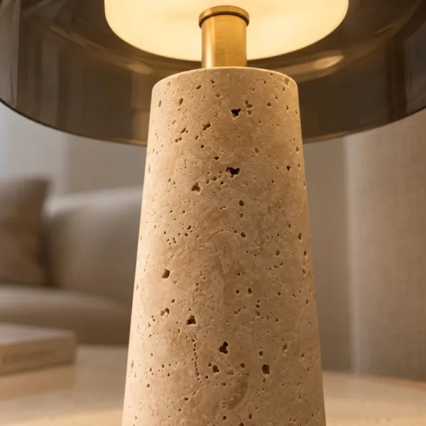 Close-up of the honed travertine cone base with its natural pits and warm cream tones