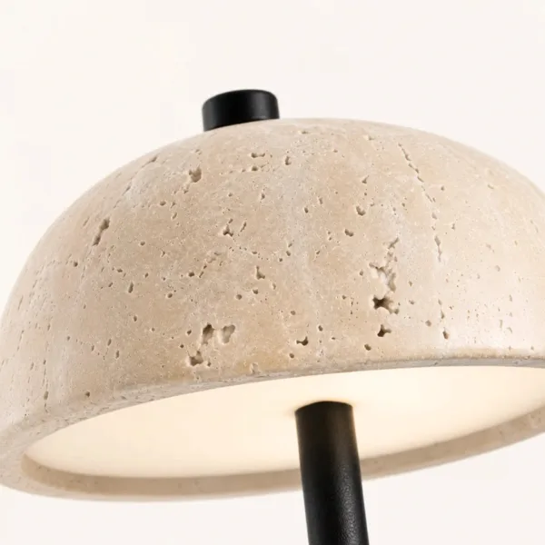 Close-up of the honed travertine dome with its natural pits and black top cap