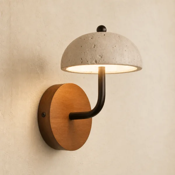 Travertine dome sconce seen at an angle: black curved stem on a round real wood backplate, lit