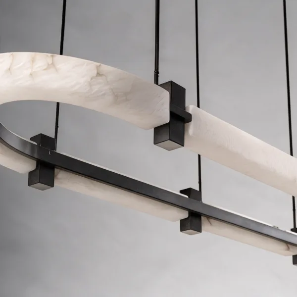 Close-up of black metal clamp joining two alabaster sections