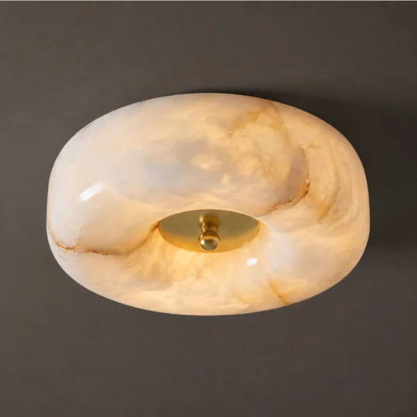 Close-up of the glowing rounded alabaster pebble and brass-finish centre cap