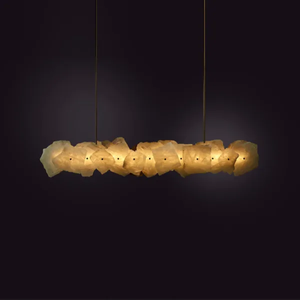 Lit brass linear chandelier, glowing band of raw alabaster slabs