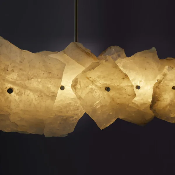 Lit raw-edged alabaster slabs on the linear chandelier, close-up
