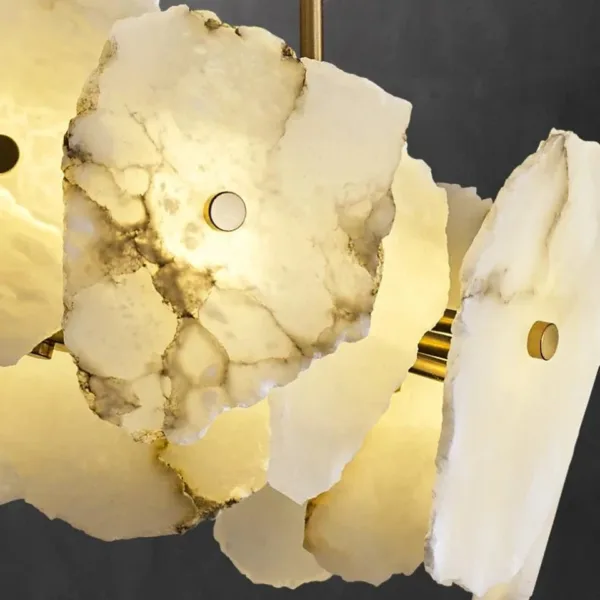 Natural alabaster slab veining and brass fittings, close-up