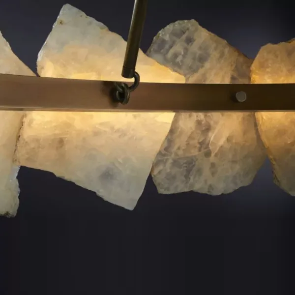 Raw-edged natural alabaster slabs close-up, bronze ring and arm