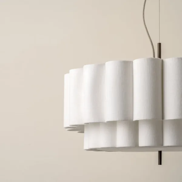 Close-up of the woven-linen scalloped columns of the two-tier pendant light