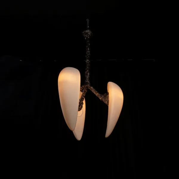 Sculptural chandelier with three lit alabaster drops on a dark textured metal stem