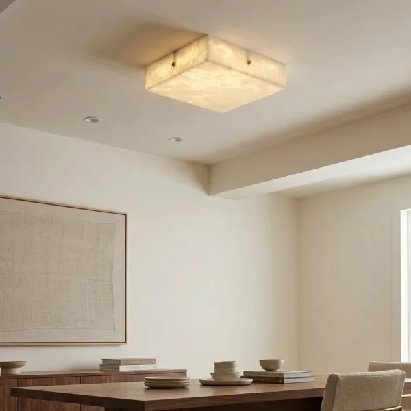 Square alabaster flush mount light above a dining table