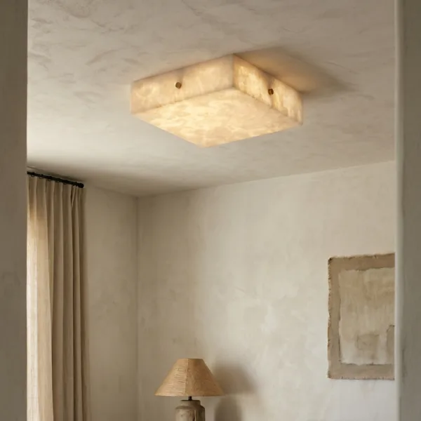 Square alabaster ceiling light glowing on a plaster ceiling