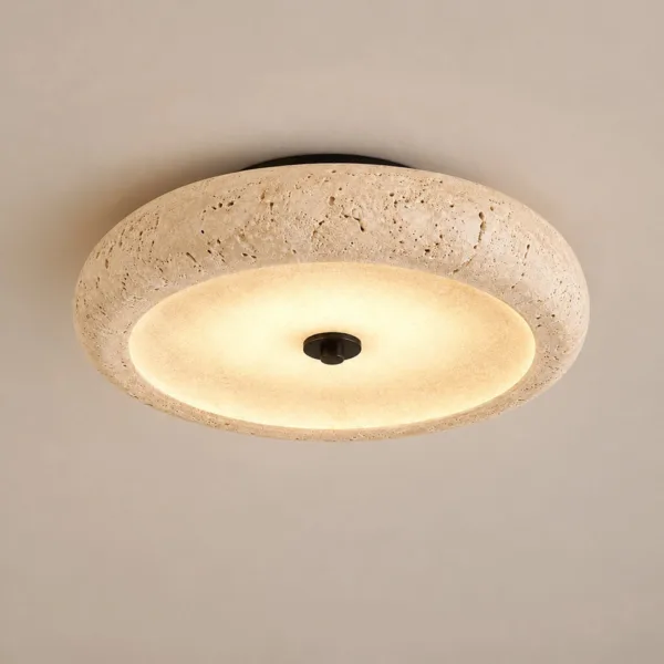Bedroom ceiling lamp with a rounded travertine rim glowing warm