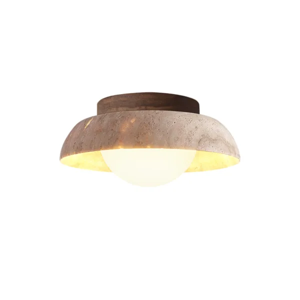 Travertine flush mount ceiling light glowing warm around an opal globe