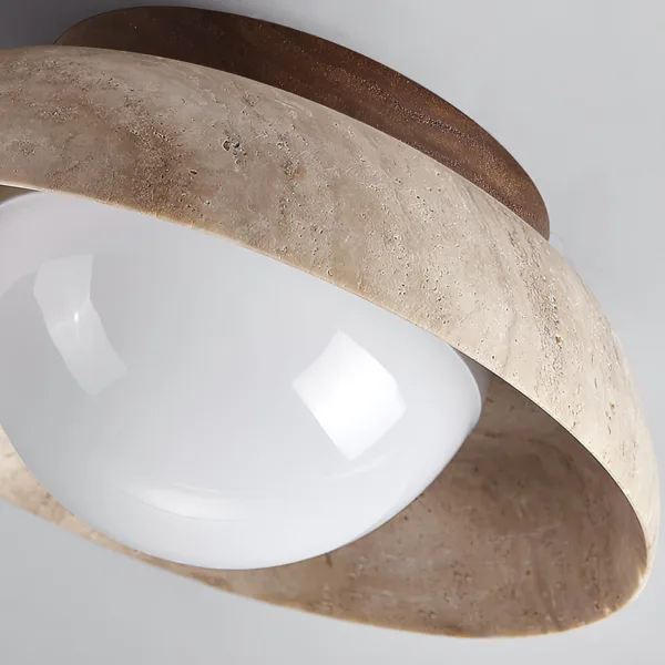 Opal borosilicate glass globe inside a hand-honed travertine bowl