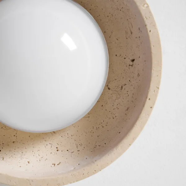 Underside of the travertine bowl around the opal glass globe
