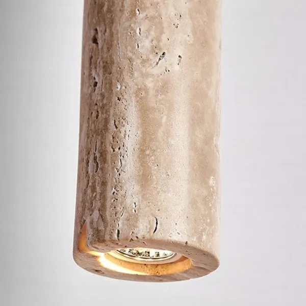 Underside of the travertine cylinder pendant light showing the built-in LED set into the stone