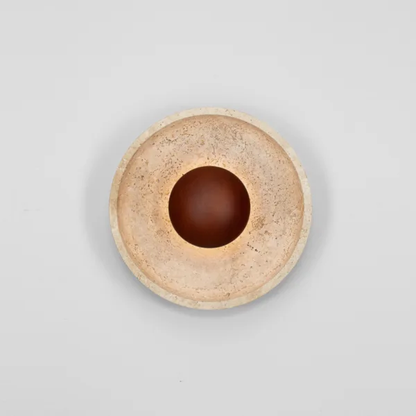 Two travertine dish wall lights, front view, on a pale grey wall